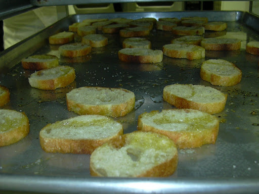 Crostini before being topped with seared scallops and pea puree.