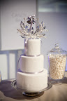 This wedding cake is part of the “Grand Romance” wedding package at Sandals Resort. It's sitting next to some champagne-bubble candies. This wedding cake is part of the “Grand Romance” wedding package at Sandals Resort. It's sitting next to some champagne-bubble candies.