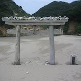 A shrine gate at Chikura Caverns, Tanegashima. We saw folks trying to toss rocks and shells onto it.