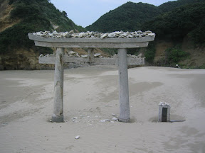 A shrine gate at Chikura Caverns, Tanegashima. We saw folks trying to toss rocks and shells onto it.