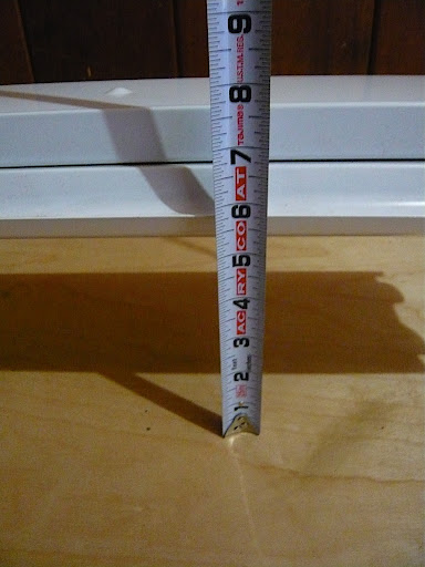 My floor is not at all level, so I used a tape measure to get both ends at an even height from the bench surface.