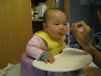 Eating her first solid (avocado)!