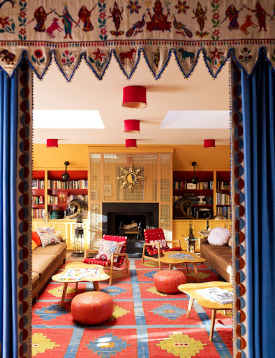 This comfortable room with built-in book shelves and Moroccan poufs was designed for lounging, but design elements from all over the world give it a cultured feel. This comfortable room with built-in book shelves and Moroccan poufs was designed for lounging, but design elements from all over the world give it a cultured feel.