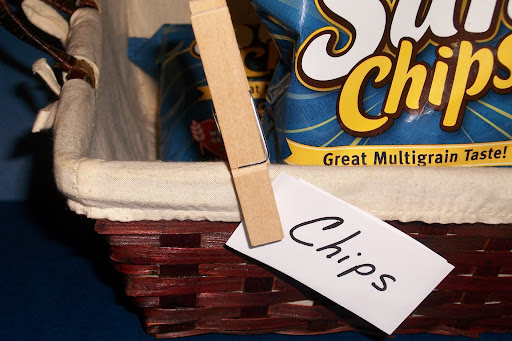 Use a clothespin to label household baskets or containers with a slip of paper.