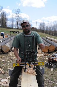 Michael drills out a mortise with a boring machine.