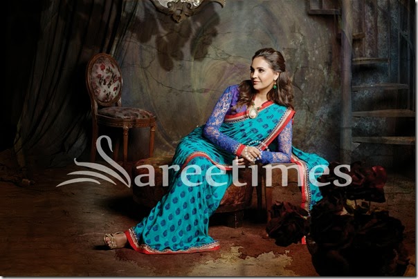 LD-20: This representation of traditional art in pure Chinon-Chiffon fabric flatters the feminine form. Paan-shaped motifs are embroidered throughout the saree in a symmetrical pattern and accentuated with complementary embellishments. The royal blue Tanchoi blouse draws attention to the gracefulness of the ensemble. LD-20: This representation of traditional art in pure Chinon-Chiffon fabric flatters the feminine form. Paan-shaped motifs are embroidered throughout the saree in a symmetrical pattern and accentuated with complementary embellishments. The royal blue Tanchoi blouse draws attention to the gracefulness of the ensemble.