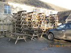 Picnic Benches piled high in the yard