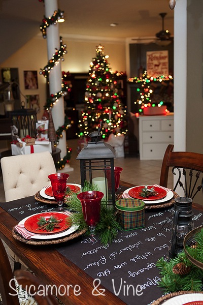 Chalkboard table runner, plaid Country Christams inspired Tablescape. A truly stunning Christmas Home Tour as part of the Christmas in the Country Blog Tour. This Plaid Inspired Country Christmas will knock your socks off. Features tours of the Living room, Dining Room and a Cocoa hot chocolate bar in the Breakfast room. There is so much inspiration for Christmas decorations in this one post. Be prepared to feel like you are cuddled up by the fire in a warm Northwoods comfy cottage! #country #Christmas #Plaid #Holiday decorating #Holiday ideas #Holidays #Christmas decor #Holiday decor Chalkboard table runner plaid Country Christams inspired Tablescape. A truly stunning Christmas Home Tour as part of the Christmas in the Country Blog Tour. This Plaid Inspired Country Christmas will knock your socks off. Features tours of the Living room, Dining Room and a Cocoa hot chocolate bar in the Breakfast room. There is so much inspiration for Christmas decorations in this one post. Be prepared to feel like you are cuddled up by the fire in a warm Northwoods comfy cottage! #country #Christmas #Plaid #Holiday decorating #Holiday ideas #Holidays #Christmas decor #Holiday decor