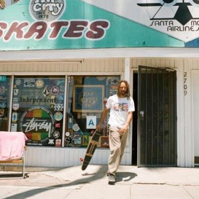 Tony coming out of a skate shop with his re-make 2012 Torger Johnson model.
