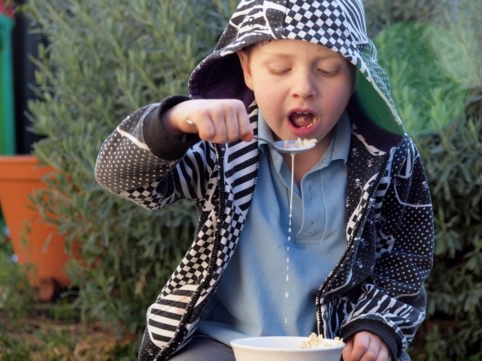 an afterschool snack - eating cereal in the yard