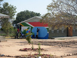 Here you can see all of us busy working on the wall and its relation to the rest of the school yard. Even our school's security guard decided to come over to help out! The new mural is right where the kids usually gather for playing on the new playground so they get a chance to look at the map and learn all the time now! South Africa - 394.jpg