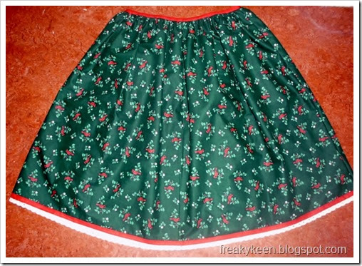 Full skirt made from cardinal and holly print fabric and trimmed with bias tape and lace.  Perfect for Christmas.