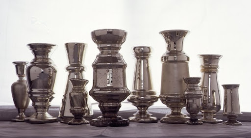Of many mercury-glass forms, the vase is the most common. The infrequently seen flask-shaped vase, belonging to Martha, lacks the usual pedestal foot. Of many mercury-glass forms, the vase is the most common. The infrequently seen flask-shaped vase, belonging to Martha, lacks the usual pedestal foot.