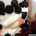 Chocolate chips and preserved strawberry on top of YoGo Premium Frozen Yogurt