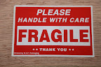 The sign says 'FRAGILE' so we better be careful.