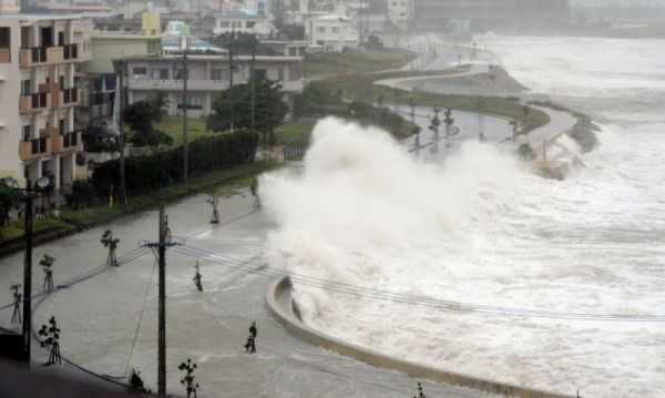 High waves pound a seawall in Yonabarucho, Prefecture, southern Japan, Sunday afternoon, 26 August 2012. Residents were being told to stay indoors and warned wind gusts from the strongest typhoon to approach Okinawa in several years could overturn cars and cause waves of up to 12 meters (40 feet) on Sunday. AP / Okinawa Times via Kyodo News