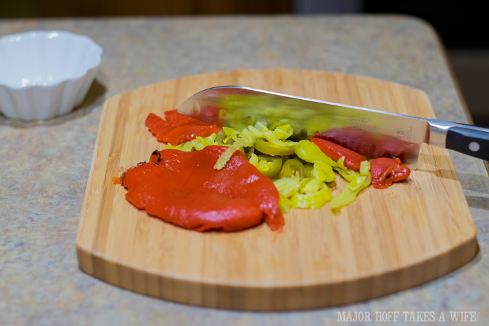 Chopping jalapenos, yellow peppers and red peppers for chicken or salad. Holiday Memories with Mezzetta! This easy lunch or dinner recipe will have you sailing through the holidays. Casual enough for everyday, but colorful enough for a holiday feast! Features 3 different peppers and packs a flavorful punch! All in less than 20 minutes! There is also a coupon for Mezzetta products as well as a chance to win 1 of 31 Holiday Gift Baskets! #MezzettaMemories #SharingJoy #Chicken #Peppers #Easy #dinner #recipe Chopping jalapenos yellow peppers and red peppers for chicken or salad. Holiday Memories with Mezzetta! This easy lunch or dinner recipe will have you sailing through the holidays. Casual enough for everyday, but colorful enough for a holiday feast! Features 3 different peppers and packs a flavorful punch! All in less than 20 minutes! There is also a coupon for Mezzetta products as well as a chance to win 1 of 31 Holiday Gift Baskets! #MezzettaMemories #SharingJoy #Chicken #Peppers #Easy #dinner #recipe