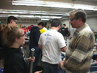 A mentor helping a student with making a part
