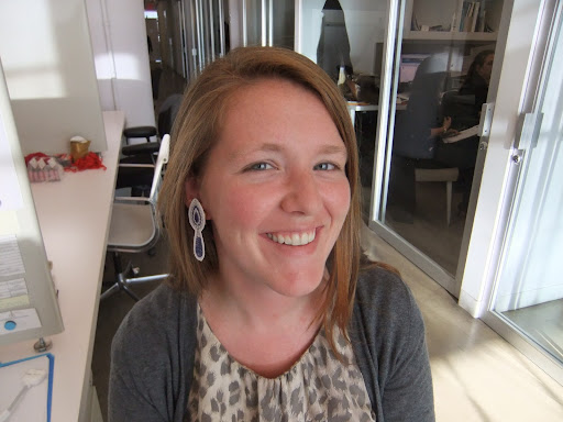 Megan Barry, digital assistant, models a pair of sapphire and diamond earrings.