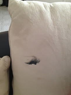 c0 Black fingernail polish stain on Clarence's couch