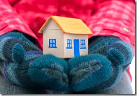 House holds woman in winter gloves 