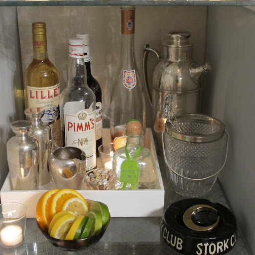 Adding a white tray really helped corral my liquor bottles. For summer, I am sticking paring down my cocktail offerings. Margaritas, Pimm's Cup, and Lillet with sliced lemon. The shakers are from a antique travel bar set. The big silver martini pitcher in the back belonged to my grandfather.