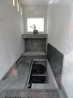 Caskets are lowered into the basement of the tomb through the steps or the covered hole in the floor.