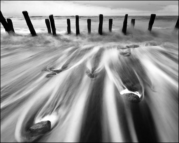 High Tide At Spurn Point. Spurn Head Coastal Defences, a facinating place, where all allong the sand there are hundreds of groynes trying to stop coastal erosion taking place and buildings that look like they have been eaten by the sea. The most memorable part though was the noise, as the North sea crashed all over this stuff it gave off a crackling noise that i have never heard before. MARK BOYLE / dphotographer.co.uk