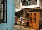 A resident removes the mud from their cabinets. (Photo by RVO/Bulatlat.com)