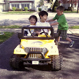 Kai and Eidan riding on the neighbor's battery powered mini Jeep Kai and Eidan riding on the neighbor's battery powered mini Jeep