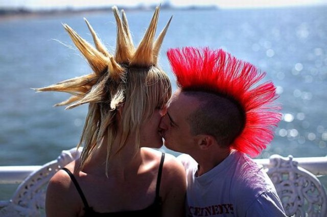 BLACKPOOL, ENGLAND - AUGUST 07: Punk lovers kiss on the Central Pier as rebels from across the world arrive for the Rebellion Festival on August 7, 2009 in Blackpool, England. Thousands of punks have descended on  Blackpool seaside resort for the annual Rebellion festival, featuring bands from the heydey of the rebel punk rock movement. The festival held in Blackpool's Winter Gardens lasts three days.  (Photo by Christopher Furlong/Getty Images)