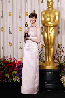 Anne Hathaway in Prada light pink duchesse satin backless column gown and Tiffany & Co. necklace. Anne Hathaway in Prada light pink duchesse satin backless column gown and Tiffany & Co. necklace.