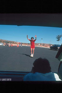 Bruce doing his famous nose wheelie with Chris Carmichael filming him in the back of Brian's station wagon for the movie Spinning Wheels at La Costa. Photo by Lance Smith
