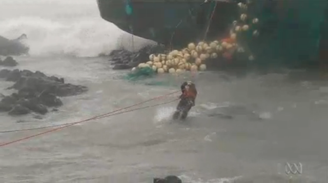 A crew member is rescued from a stranded ship as Typhoon Bolaven hits Korea, 27 August 2012. abc.net.au