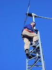 Partner Dan Creighton installing a Southwest Wind Power turbine in 2006.