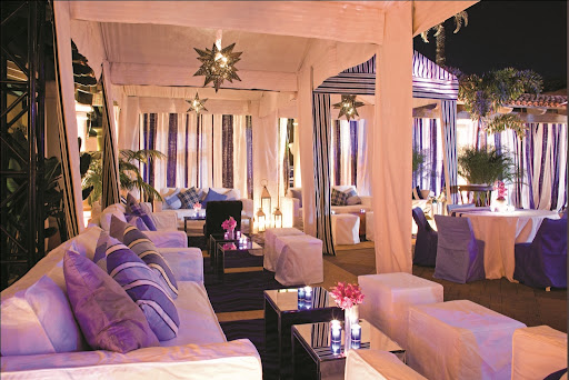 For a private party on the beach, Bronson utilized a group of blue and white cabanas. For a private party on the beach, Bronson utilized a group of blue and white cabanas.
