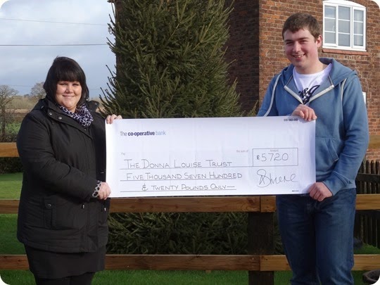 Nikki Wrench from The Donna Louise Childrens Hospice  receives the cheque from Graham Witter