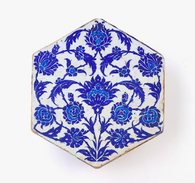 Tile | Origin:  Iznik,  Turkey | Period: ca. 1525-50  Ottoman period | Details:  During the early sixteenth century, Iznik ceramic production focused primarily on vessels. With the accession of the Ottoman ruler Sultan Sulayman (reigned 1522Â–60), and his ambitious building projects throughout the empire, demand for Iznik tiles grew and rivaled that for ceramic objects. The elegant design of this blue-and-white tile, combining full lotus flowers, broken stems, and serrated leaves, finds many parallels in contemporary ink drawings, textiles, and manuscript illumination. By drawing on a distinct body of designs and skillfully adapting these to different media, sixteenth-century Ottoman artists lend their work a recognizable visual unity and artistic identity. | Type: Stone-paste painted under glaze | Size:   H: 27.8  W: 24.4   D: 2.8  cm | Museum Code: F1998.298 | Photograph and description taken from Freer and the Sackler (Smithsonian) Museums.