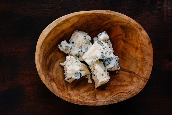 Chunks of blue cheese in a wooden bowl blue cheese.jpg