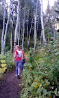 Sami & Griff hike through a grove of aspens