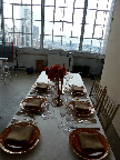 The red table in the beginning stages of being set.