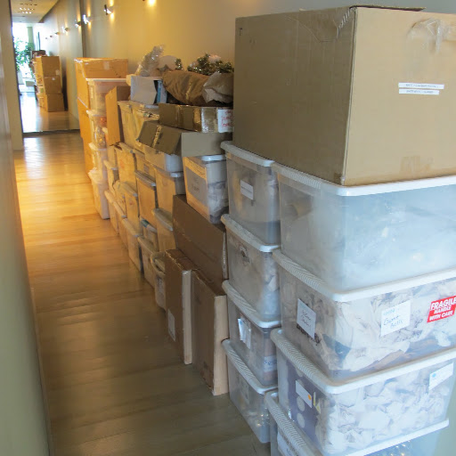 Several boxes and storage containers filled with decorations and ornaments are lining my hallway.