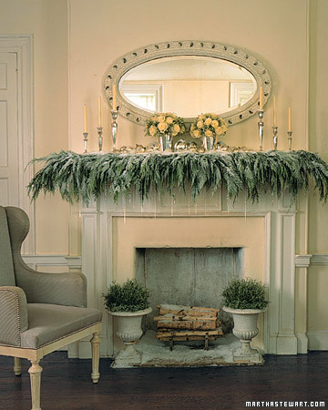 Dripping crystal icicles dangle from a cedar-covered, snow-dusted mantelpiece to create a frosty scene. And iron urns are filled with silvery santolina. Dripping crystal icicles dangle from a cedar-covered, snow-dusted mantelpiece to create a frosty scene. And iron urns are filled with silvery santolina.
