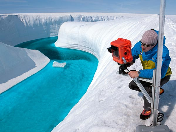 Adam LeWinter installs a camera on the Greenland ice sheet in 2009. The polar ice sheets are indeed shrinking—and fast, according to a comprehensive 2012 study on climate change.  James Balog / National Geographic