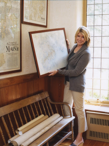Martha hanging maps in a passageway at Skylands (Martha Stewart Living, June 2007)