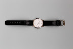 Alex wore a Classima collection Baume & Mercier watch. It is a traditional gift for a groom on his wedding day.