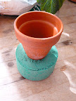 I used oasis in the clay pot instead of potting mix. Oasis is a water absorbent foam that florist for making arrangements. I used the bottom of the pot to measure the diameter I needed.