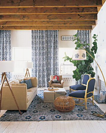 Rebecca's living room is another example of the proper way to use pattern. The monochromatic color scheme keeps things calm even though there is a great deal of pattern. A graphic damask fabric was used for the floor-to-ceiling curtains in the living area. The floral rug is by British designer Neisha Crosland. Rebecca's living room is another example of the proper way to use pattern. The monochromatic color scheme keeps things calm even though there is a great deal of pattern. A graphic damask fabric was used for the floor-to-ceiling curtains in the living area. The floral rug is by British designer Neisha Crosland.