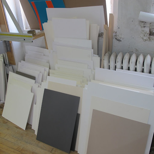 Mat boards are stacked at the side of the room.