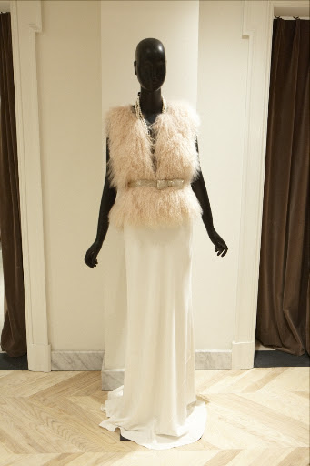 This wedding dress is accessorized with a Mongolian fur vest and sparkly bow belt. This wedding dress is accessorized with a Mongolian fur vest and sparkly bow belt.